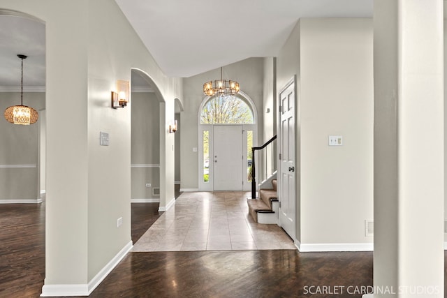 2716 Whitchurch Ct, Naperville, IL 60564 - entrance foyer featuring arched walkways, baseboards, high vaulted ceiling, and a notable chandelier