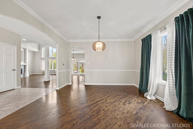 2716 Whitchurch Ct, Naperville, IL 60564 - unfurnished dining area featuring arched walkways, baseboards, ornamental molding, and wood finished floors