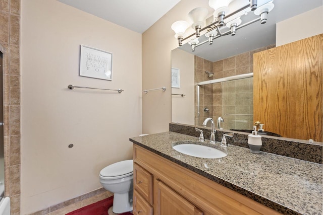 bathroom featuring toilet, tiled shower, and vanity