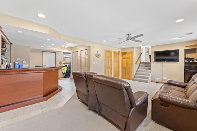 living room featuring a ceiling fan, visible vents, stairs, recessed lighting, and light tile patterned flooring