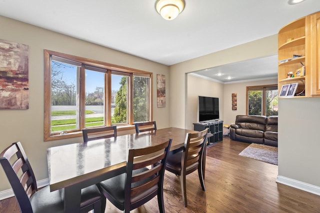 dining room with crown molding, dark wood-style flooring, baseboards, and recessed lighting