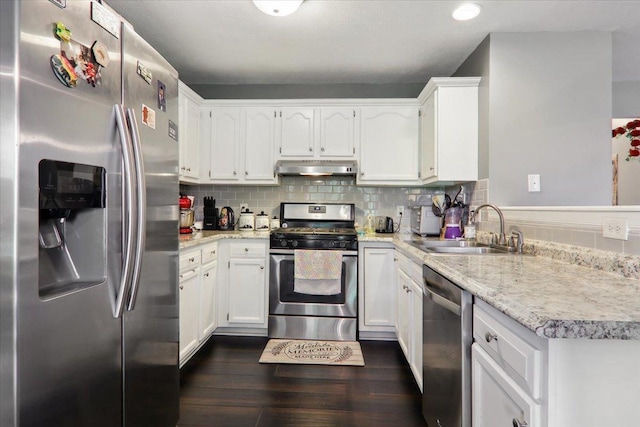 2 Reading Rd, Bloomington, IL 61701 - kitchen featuring dark wood-style floors, under cabinet range hood, white cabinets, a sink, and appliances with stainless steel finishes