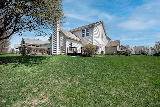 back of property with a lawn and a chimney