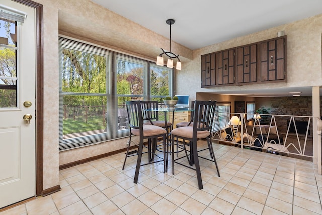 dining area featuring light tile patterned floors and plenty of natural light
