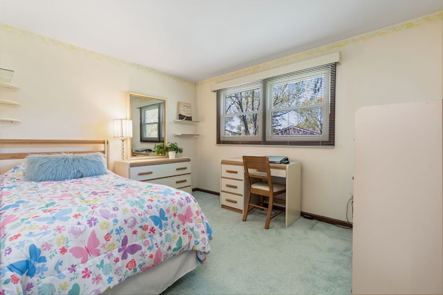 bedroom with light carpet and baseboards