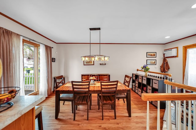 dining area with ornamental molding, light wood-type flooring, a chandelier, a wall mounted AC, and recessed lighting