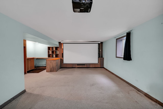 carpeted home theater room featuring baseboards