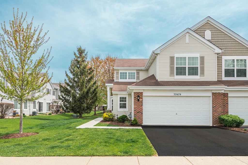 32479 N Allegheny Way Unit 32479, Lakemoor, IL 60051 - multi unit property with brick siding, an attached garage, a front lawn, and aphalt driveway