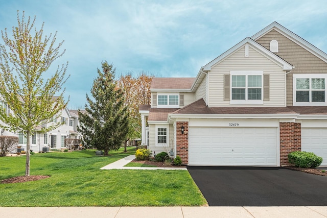 32479 N Allegheny Way Unit 32479, Lakemoor, IL 60051 - multi unit property with brick siding, an attached garage, a front lawn, and aphalt driveway