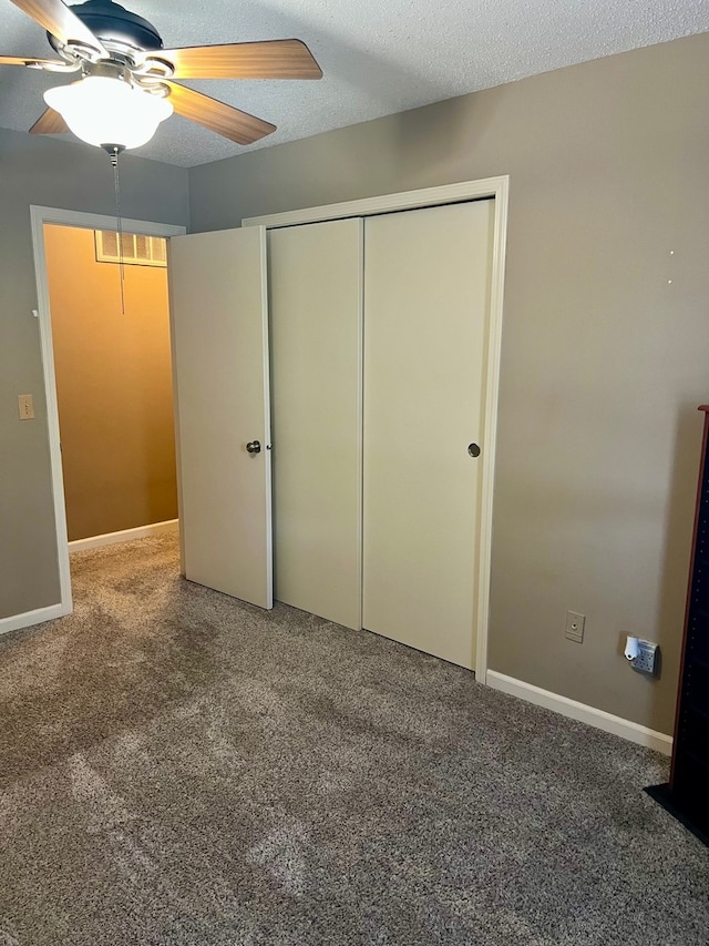 unfurnished bedroom featuring a ceiling fan, visible vents, baseboards, a closet, and carpet