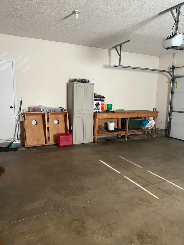 garage with a workshop area and a garage door opener