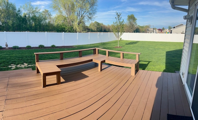 wooden terrace featuring a fenced backyard and a yard