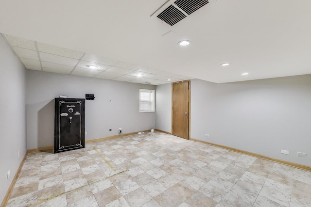 basement featuring baseboards, recessed lighting, and stone finish floors