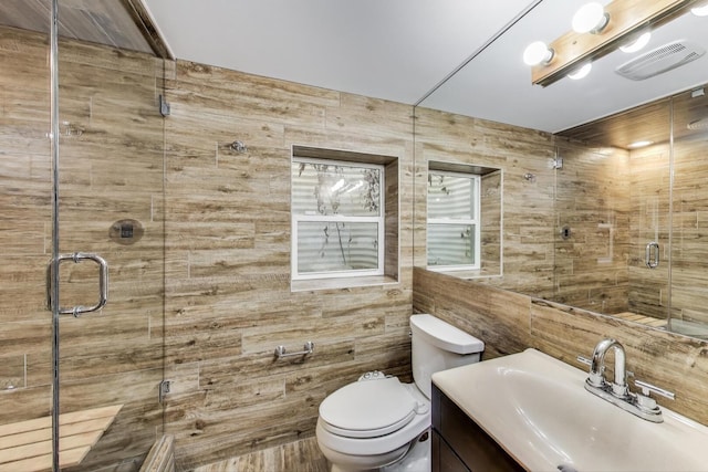full bathroom with a shower stall, toilet, and vanity