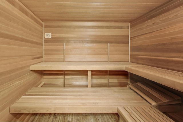 relaxing sauna / steam room with wood ceiling and wooden walls