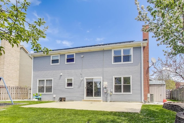 rear view of property featuring a patio, a chimney, a shed, an outbuilding, and central AC unit