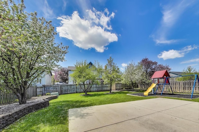 view of yard featuring a playground and a patio