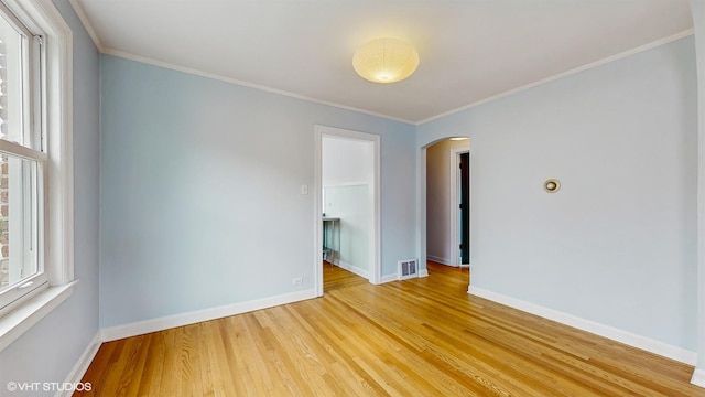 1730 Madison St, Evanston, IL 60202 - unfurnished room with arched walkways, light wood-style floors, baseboards, and ornamental molding