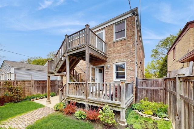1730 Madison St, Evanston, IL 60202 - rear view of house featuring a fenced backyard, brick siding, a wooden deck, and a patio