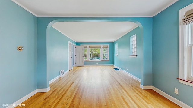 1730 Madison St, Evanston, IL 60202 - spare room featuring arched walkways, wood finished floors, baseboards, and ornamental molding