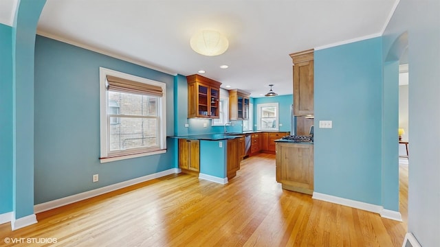 1730 Madison St, Evanston, IL 60202 - kitchen featuring brown cabinets, glass insert cabinets, baseboards, light wood finished floors, and arched walkways