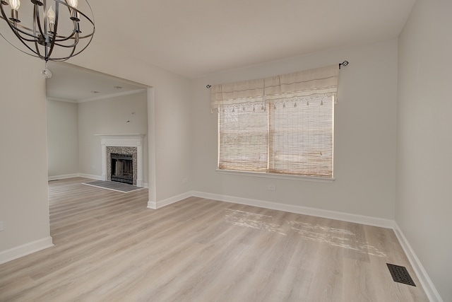 1877 Westmore Grove Dr, Plainfield, IL 60586 - unfurnished living room featuring a chandelier, light wood finished floors, a tile fireplace, and baseboards