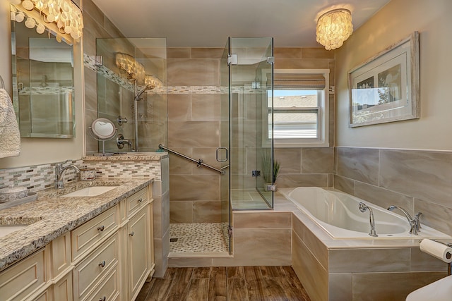 1877 Westmore Grove Dr, Plainfield, IL 60586 - bathroom featuring a garden tub, a stall shower, double vanity, wood finished floors, and decorative backsplash