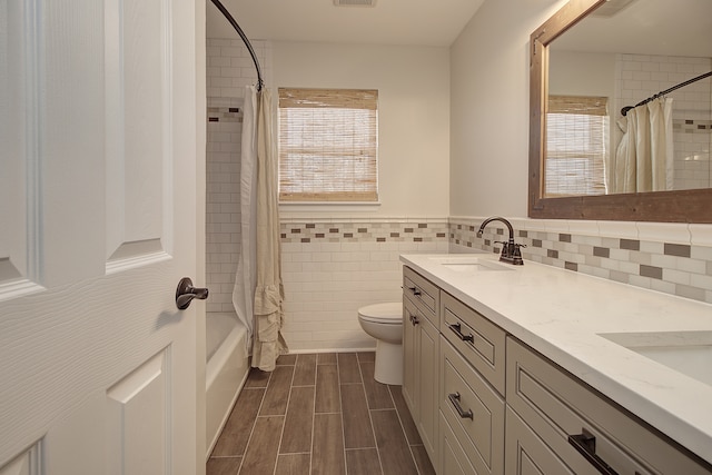 1877 Westmore Grove Dr, Plainfield, IL 60586 - bathroom with double vanity, shower / bathtub combination with curtain, toilet, tile walls, and wainscoting