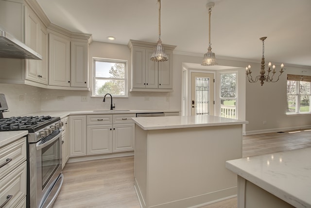 1877 Westmore Grove Dr, Plainfield, IL 60586 - kitchen with stainless steel range with gas stovetop, a sink, wall chimney range hood, decorative backsplash, and a kitchen island