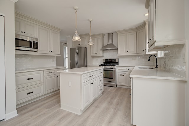 1877 Westmore Grove Dr, Plainfield, IL 60586 - kitchen with appliances with stainless steel finishes, wall chimney range hood, a sink, a center island, and light wood-style flooring
