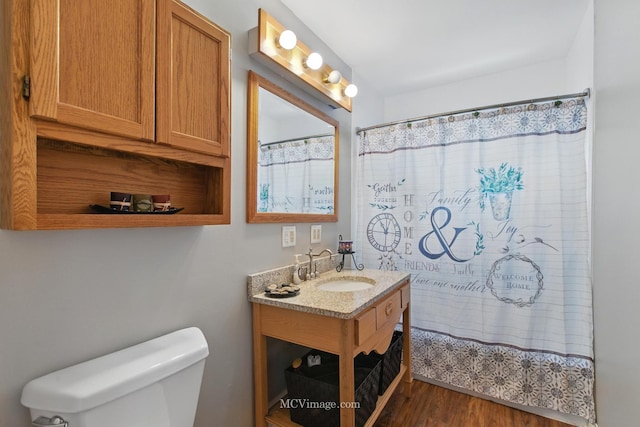 full bathroom with vanity, a shower with shower curtain, wood finished floors, and toilet