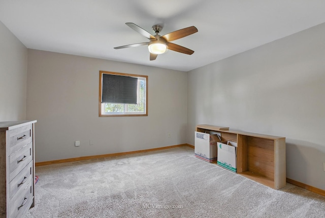 interior space with ceiling fan, light carpet, and baseboards