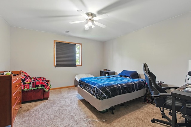 carpeted bedroom with baseboards, a ceiling fan, and visible vents
