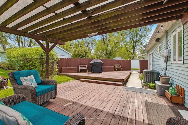 wooden terrace featuring central air condition unit, grilling area, and a fenced backyard