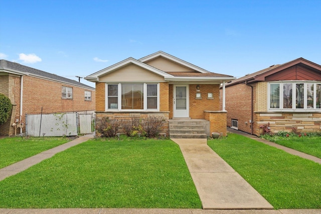 bungalow-style home with brick siding, a gate, a front lawn, and fence