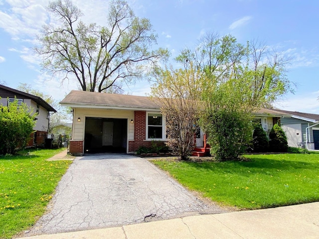 ranch-style house with brick siding, an attached garage, driveway, and a front yard
