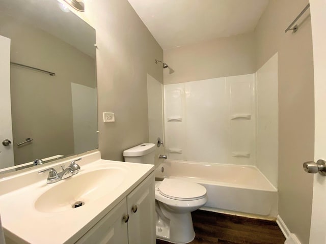 bathroom with shower / bath combination, vanity, toilet, and wood finished floors
