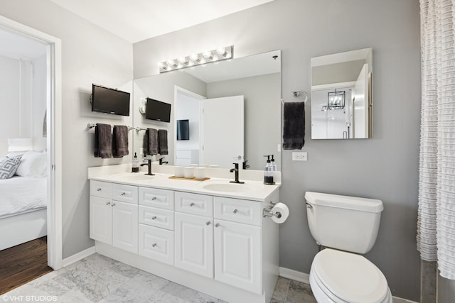 full bath featuring a sink, ensuite bathroom, and toilet