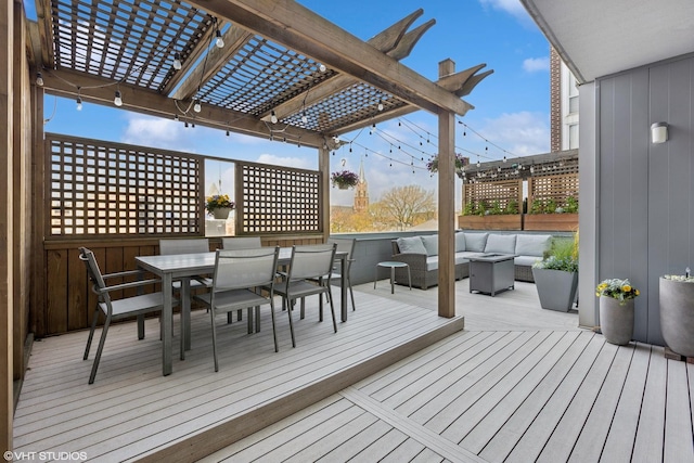 deck featuring a pergola, an outdoor hangout area, and outdoor dining space