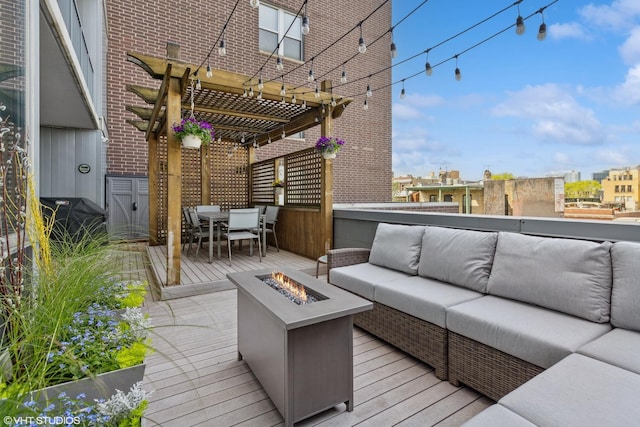wooden deck featuring an outdoor living space with a fire pit, a pergola, and outdoor dining space