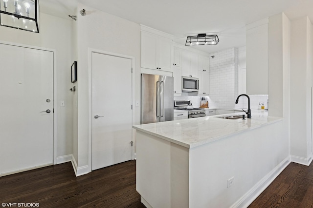 kitchen featuring a sink, dark wood-style flooring, high end appliances, and white cabinets