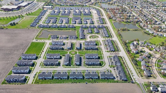 birds eye view of property featuring a water view and a residential view
