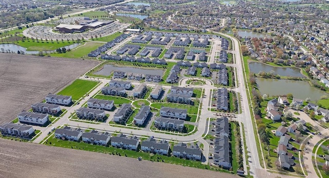 drone / aerial view with a residential view and a water view