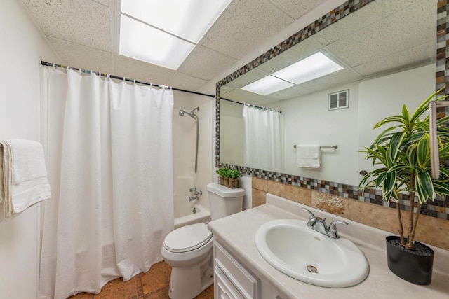 full bathroom featuring visible vents, toilet, shower / bathtub combination with curtain, and a paneled ceiling