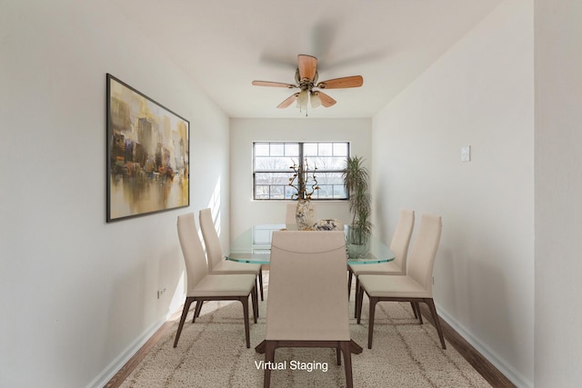 dining space featuring baseboards and ceiling fan