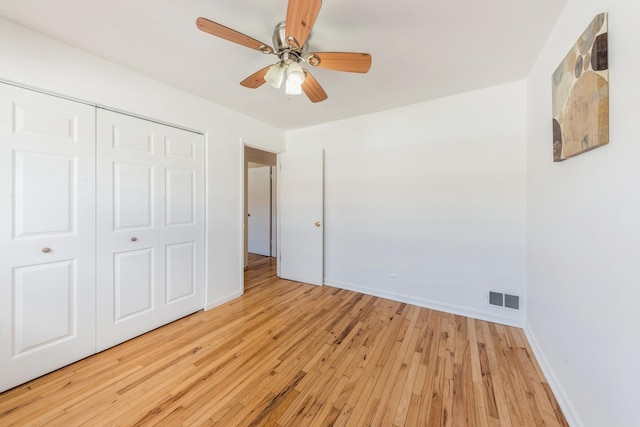 unfurnished bedroom with visible vents, a closet, baseboards, ceiling fan, and light wood-type flooring