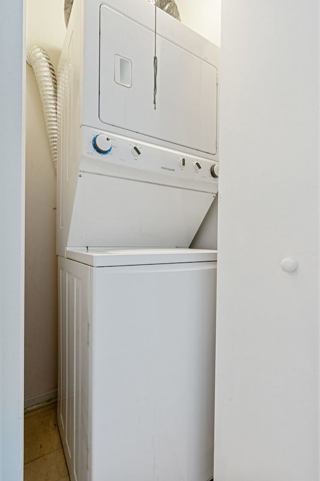 1530 S State St Unit 523, Chicago, IL 60605 - clothes washing area with light tile patterned floors, laundry area, and stacked washer and dryer