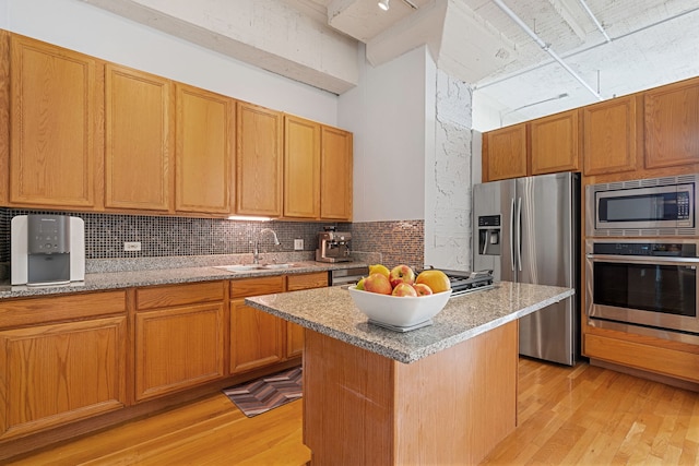 1530 S State St Unit 523, Chicago, IL 60605 - kitchen featuring a sink, appliances with stainless steel finishes, decorative backsplash, and light wood finished floors