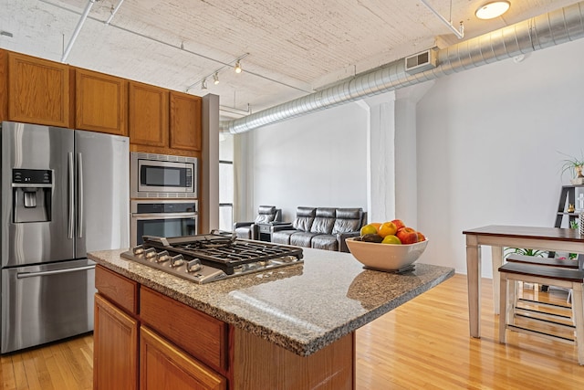 1530 S State St Unit 523, Chicago, IL 60605 - kitchen featuring track lighting, light wood finished floors, a center island, stainless steel appliances, and visible vents
