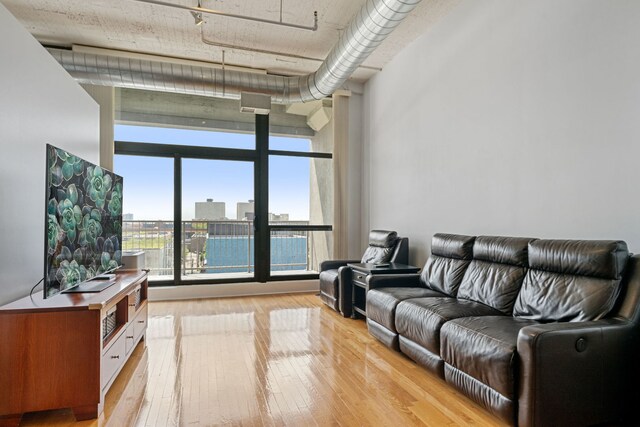 1530 S State St Unit 523, Chicago, IL 60605 - living room with a wall of windows and light wood-style flooring